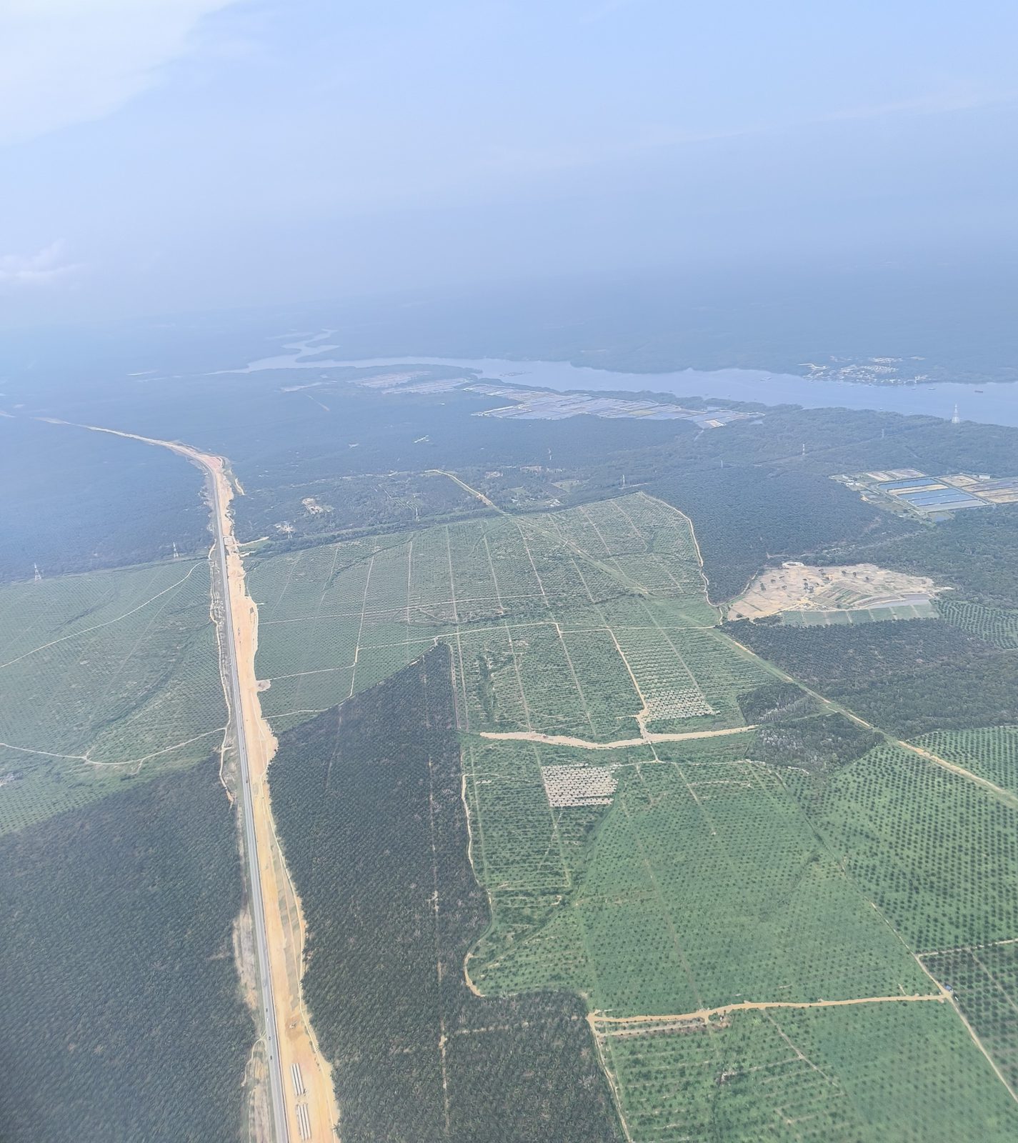 A new highway running straight through forest and oil palm, Johor, Malaysia