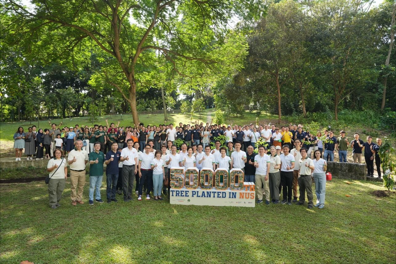 Group photograph at the marker for the 50,000th tree planted at NUS